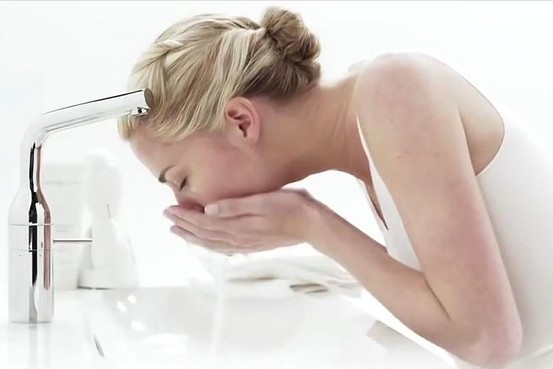 Woman washing her face